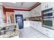 Bright kitchen with white cabinets, granite countertops, stainless appliances and a tiled backsplash at 2641 Loch Way, Snellville, GA 30039