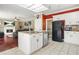 Well-lit kitchen featuring a central island with granite countertops and stainless steel appliances at 2641 Loch Way, Snellville, GA 30039