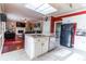Open kitchen with granite counters, an island and stainless steel appliances overlooks the living area at 2641 Loch Way, Snellville, GA 30039