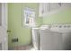 Functional laundry room with a washer and dryer, and storage cabinets at 2641 Loch Way, Snellville, GA 30039