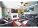 Inviting living room featuring a fireplace, hardwood floors, and a ceiling fan at 2641 Loch Way, Snellville, GA 30039