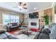 Comfortable living room featuring plush sofas, a fireplace, and hardwood floors at 2641 Loch Way, Snellville, GA 30039