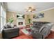 Inviting living room with a cozy fireplace, comfortable seating, and bright natural light at 2641 Loch Way, Snellville, GA 30039
