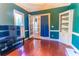 Cozy home office with dark green walls, built-in shelving, and hardwood floors at 2641 Loch Way, Snellville, GA 30039
