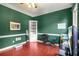 Well-lit office space featuring rich hardwood floors, built-in shelving and neutral wall color at 2641 Loch Way, Snellville, GA 30039