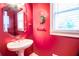 Small powder room with a window, pedestal sink and bright paint at 2641 Loch Way, Snellville, GA 30039