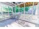 Relaxing screened porch with white lattice, a ceiling fan, and outdoor furniture for enjoying the outdoors at 2641 Loch Way, Snellville, GA 30039