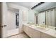 Bathroom featuring double sinks, a large mirror, and tiled floors at 2660 Peachtree Nw Rd # 13H, Atlanta, GA 30305