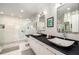 Modern bathroom with double sinks and a glass walk-in shower at 2660 Peachtree Nw Rd # 13H, Atlanta, GA 30305