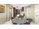Cozy breakfast nook with a round table, stylish chairs, and access to a balcony at 2660 Peachtree Nw Rd # 13H, Atlanta, GA 30305