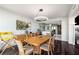 Bright dining room features hardwood floors, modern lighting, and a dining table that seats six at 2660 Peachtree Nw Rd # 13H, Atlanta, GA 30305