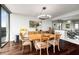 Bright dining room features hardwood floors, modern lighting, and a dining table that seats six at 2660 Peachtree Nw Rd # 13H, Atlanta, GA 30305