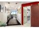 Bright hallway featuring hardwood floors, modern lighting fixtures, and a decorative sliding door at 2660 Peachtree Nw Rd # 13H, Atlanta, GA 30305