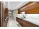 Long kitchen featuring stylish wood cabinets and marble countertops at 2660 Peachtree Nw Rd # 13H, Atlanta, GA 30305