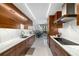 Modern kitchen featuring marble countertops and stylish wood cabinets at 2660 Peachtree Nw Rd # 13H, Atlanta, GA 30305