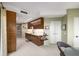 This kitchenette boasts wood cabinetry and modern lighting at 2660 Peachtree Nw Rd # 13H, Atlanta, GA 30305