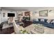Large living area with modern furniture, large television, and stylish hardwood flooring at 2660 Peachtree Nw Rd # 13H, Atlanta, GA 30305