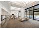 Lobby with modern furniture, large windows overlooking the pool, and a bar area at 2660 Peachtree Nw Rd # 13H, Atlanta, GA 30305