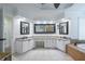 Large bathroom boasts a vanity, framed mirrors and soaking tub at 5589 Forkwood Nw Dr, Acworth, GA 30101