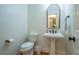 Charming half bathroom featuring a pedestal sink, and toilet at 5589 Forkwood Nw Dr, Acworth, GA 30101