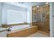 Spa-like bathroom with a soaking tub, and glass-enclosed shower at 5589 Forkwood Nw Dr, Acworth, GA 30101