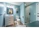 This updated bathroom features blue paint, and a shower with a black frame and glass door at 5589 Forkwood Nw Dr, Acworth, GA 30101
