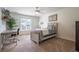 This bedroom has a work desk near the window, neutral paint, carpet and a ceiling fan at 5589 Forkwood Nw Dr, Acworth, GA 30101