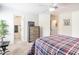 This bedroom has carpet and a ceiling fan and a bathroom is visible through a door on the left at 5589 Forkwood Nw Dr, Acworth, GA 30101