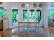 Eat-in dining area with access to the deck, view to the backyard, and view of living room at 5589 Forkwood Nw Dr, Acworth, GA 30101