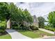 Beautiful brick home with a well-kept lawn, mature trees, and a long driveway leading to the garage at 5589 Forkwood Nw Dr, Acworth, GA 30101