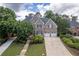 Aerial view of a brick home boasting lush landscaping, a two-car garage, and inviting curb appeal at 5589 Forkwood Nw Dr, Acworth, GA 30101