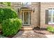 A charming brick home entrance with an ornate glass front door, brick steps, and manicured landscaping at 5589 Forkwood Nw Dr, Acworth, GA 30101