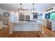 Bright kitchen featuring stainless steel appliances, a large island, and hardwood floors at 5589 Forkwood Nw Dr, Acworth, GA 30101