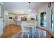 Open concept kitchen and dining area features hardwood floors, stainless appliances and backyard access at 5589 Forkwood Nw Dr, Acworth, GA 30101