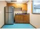 Kitchenette with stainless steel fridge, wooden cabinets, sink, and blue tile flooring for a cozy feel at 5589 Forkwood Nw Dr, Acworth, GA 30101
