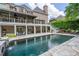 Serene backyard featuring a spacious pool, stone patio, and lush landscaping creating a private oasis at 5589 Forkwood Nw Dr, Acworth, GA 30101