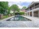 Beautiful backyard with a sparkling pool, a stone patio, and ample space for outdoor entertaining at 5589 Forkwood Nw Dr, Acworth, GA 30101