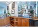 Home wet bar with display shelves, wood cabinetry and mirrored backsplash at 5589 Forkwood Nw Dr, Acworth, GA 30101