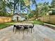 Landscaped backyard featuring stone patio, outdoor dining area, play set, and garden shed at 1443 Metropolitan Se Ave, Atlanta, GA 30316