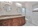 Bright bathroom featuring double vanity, granite counters, walk-in shower, and white tile at 1443 Metropolitan Se Ave, Atlanta, GA 30316