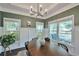 Elegant dining room with large windows, a stylish chandelier, and ample seating at 1443 Metropolitan Se Ave, Atlanta, GA 30316