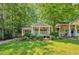 Charming bungalow with a welcoming front porch, mature trees, and lush landscaping at 1443 Metropolitan Se Ave, Atlanta, GA 30316