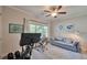 Bright office space with a couch, desk, and Peloton bike at 1443 Metropolitan Se Ave, Atlanta, GA 30316
