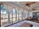Relaxing sunroom features white curtains, wooden ceiling fans and matching wooden furniture at 1443 Metropolitan Se Ave, Atlanta, GA 30316