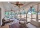 Relaxing sunroom with lots of seating, wood floors, curtains, and two ceiling fans at 1443 Metropolitan Se Ave, Atlanta, GA 30316