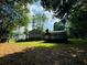 Mature trees offering plenty of shade and privacy in this beautiful backyard with a deck at 3210 Ebenezer Rd, Marietta, GA 30066