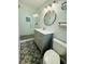 Modern bathroom with decorative tile flooring, glass shower, gray vanity, and unique mirror at 3210 Ebenezer Rd, Marietta, GA 30066