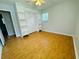 Bright bedroom featuring gleaming hardwood floors, ceiling fan and built-in shelving at 3210 Ebenezer Rd, Marietta, GA 30066