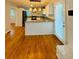 Open-concept kitchen featuring granite countertops, stainless steel appliances, and hardwood flooring at 3210 Ebenezer Rd, Marietta, GA 30066