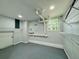 Bright laundry room with sleek epoxy floor, wire rack shelving, and window at 3210 Ebenezer Rd, Marietta, GA 30066